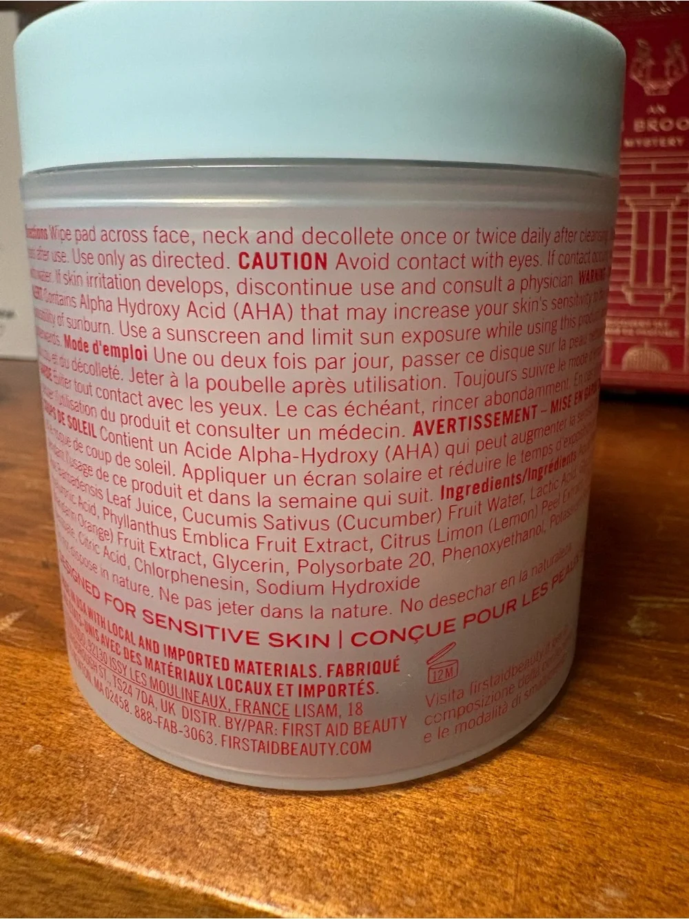 First Aid Beauty white jar with bold red logo Facial Radiance Pads